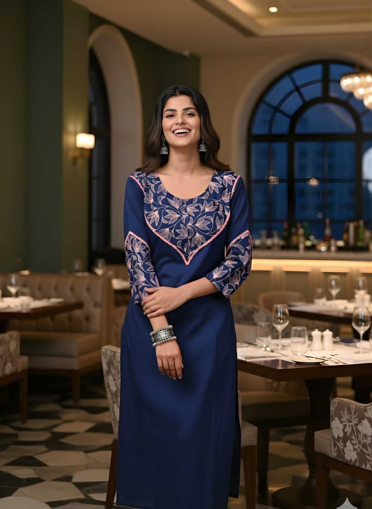 Woman in a blue dress standing in a restaurant setting