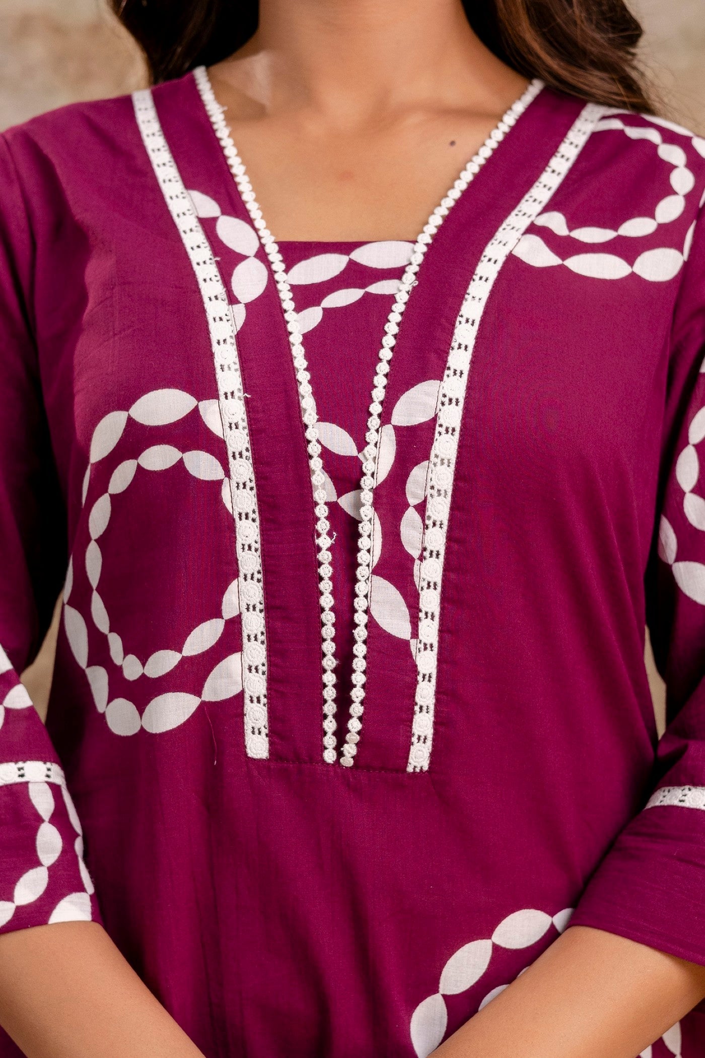 Purple dress with white embroidery on a neutral background
