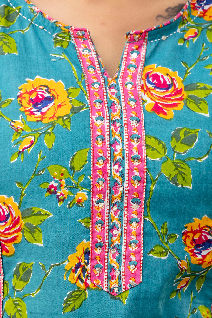 Floral patterned fabric with colorful embroidery on a blue background