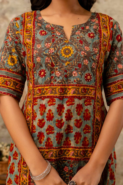 Person wearing a colorful patterned dress with a blurred background