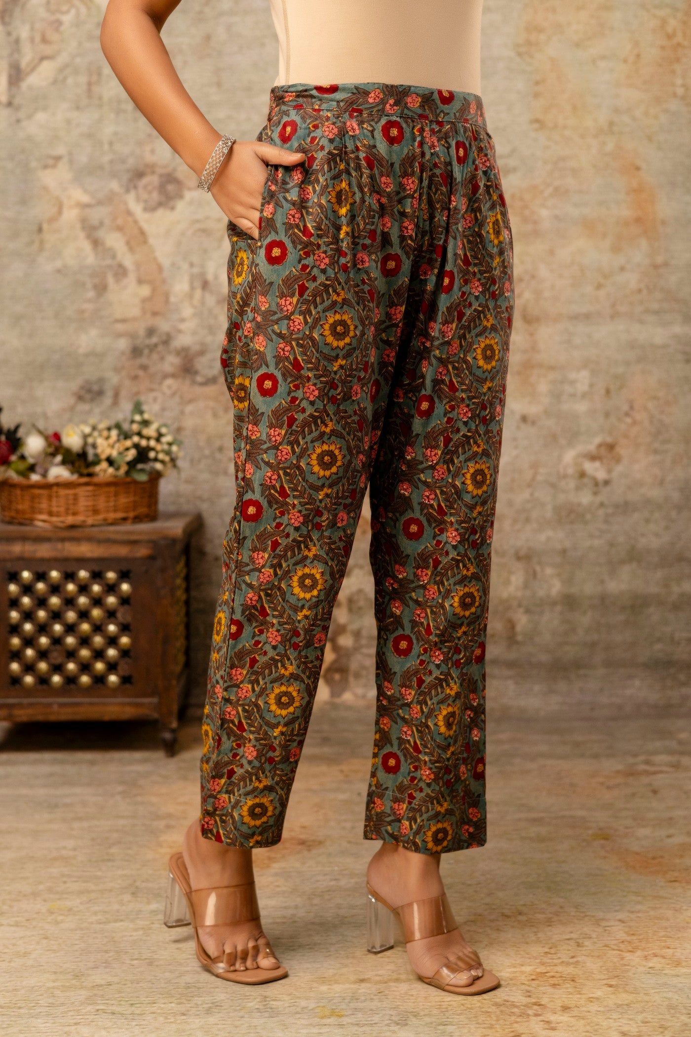 Floral patterned pants worn by a person in a rustic setting.