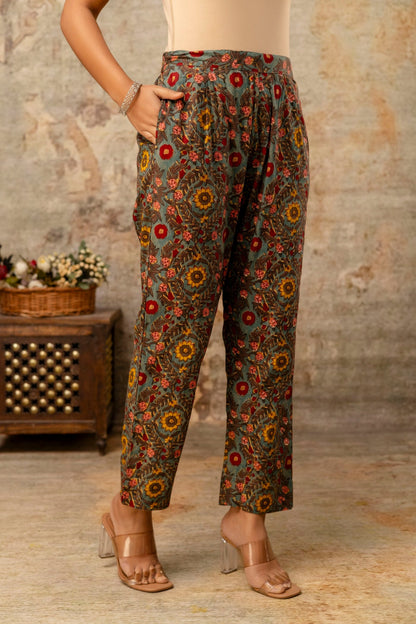 Floral patterned pants worn by a person in a rustic setting.