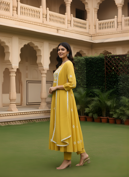 Woman in a yellow traditional outfit standing in front of a classical architectural building.