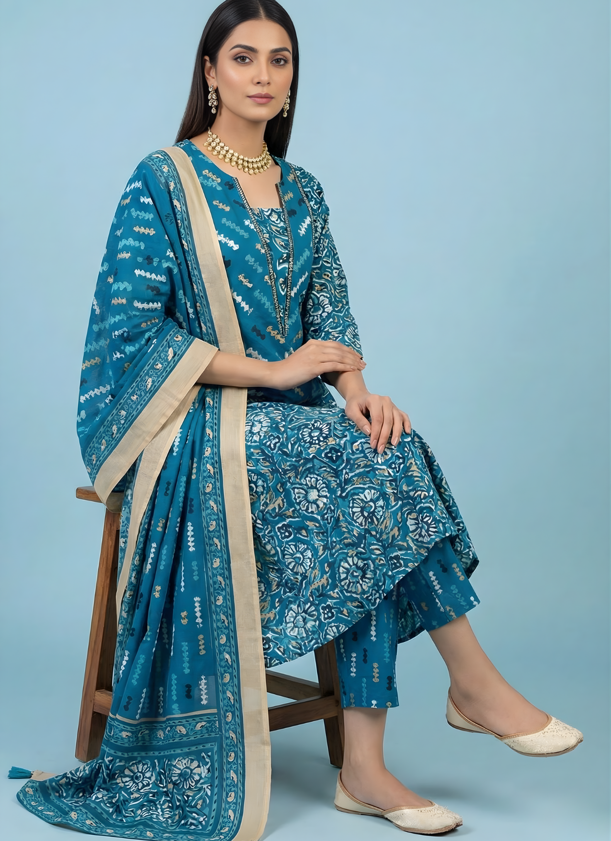 Woman in a blue traditional outfit with a beige sash on a light blue background