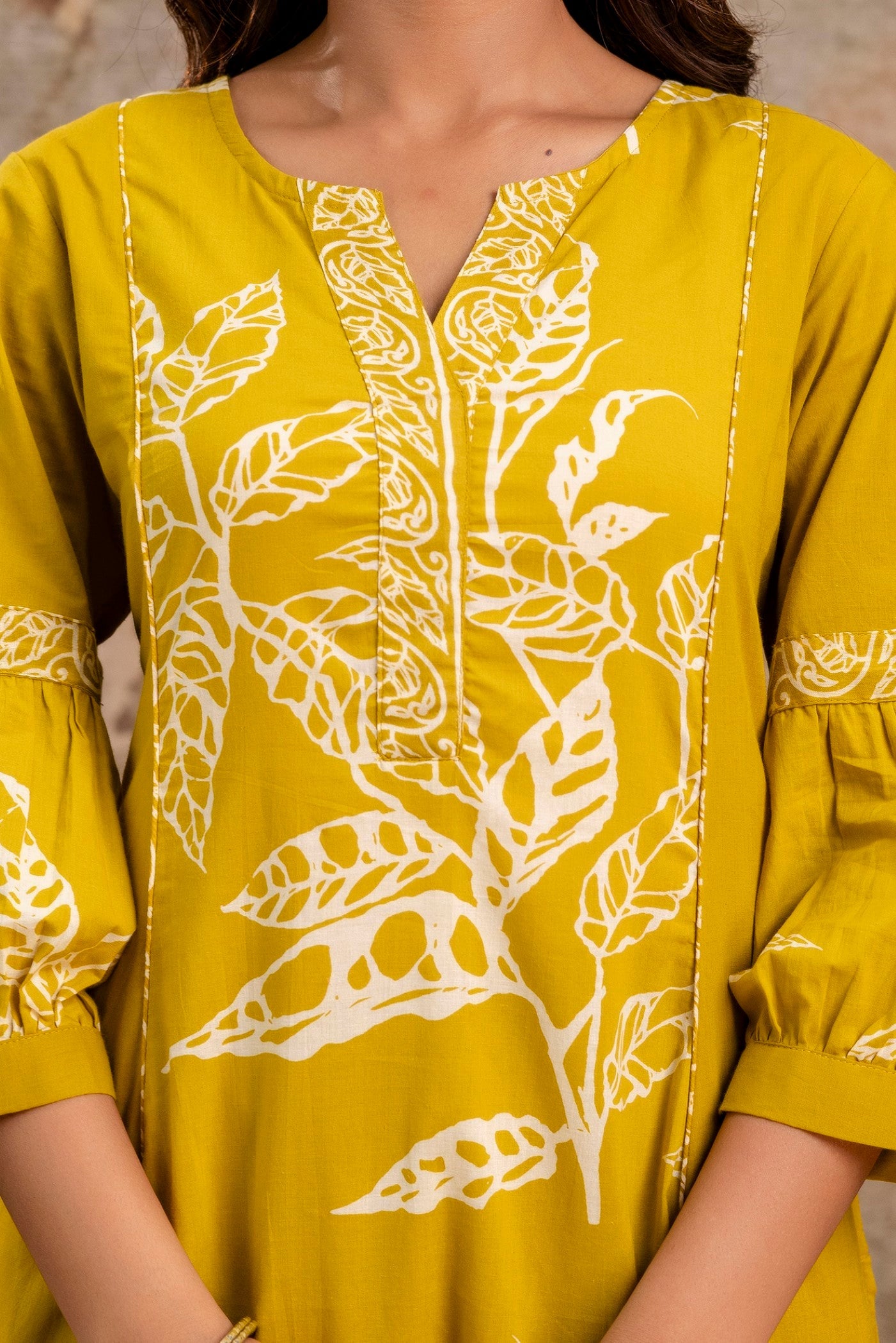 Close-up of white handblock leaf motifs on cotton fabric